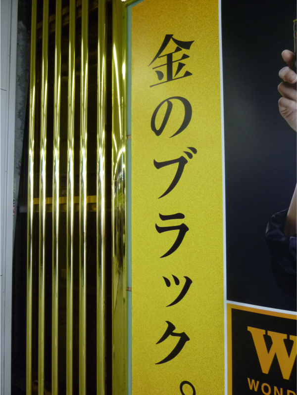 金色のシートが貼られたポスター枠と柵